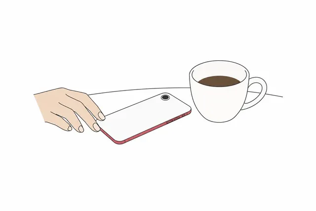 テーブルに伏せて置かれたスマートフォンの挿絵